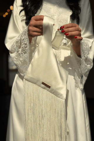 Ivory satin fringe pouch with knotted handle by Venus Karma